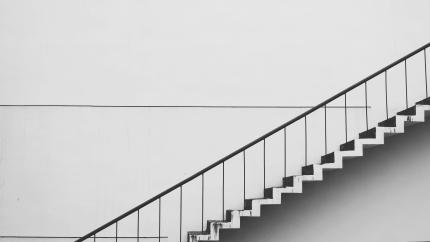 Image of a flight of stairs crossing a gentle white background